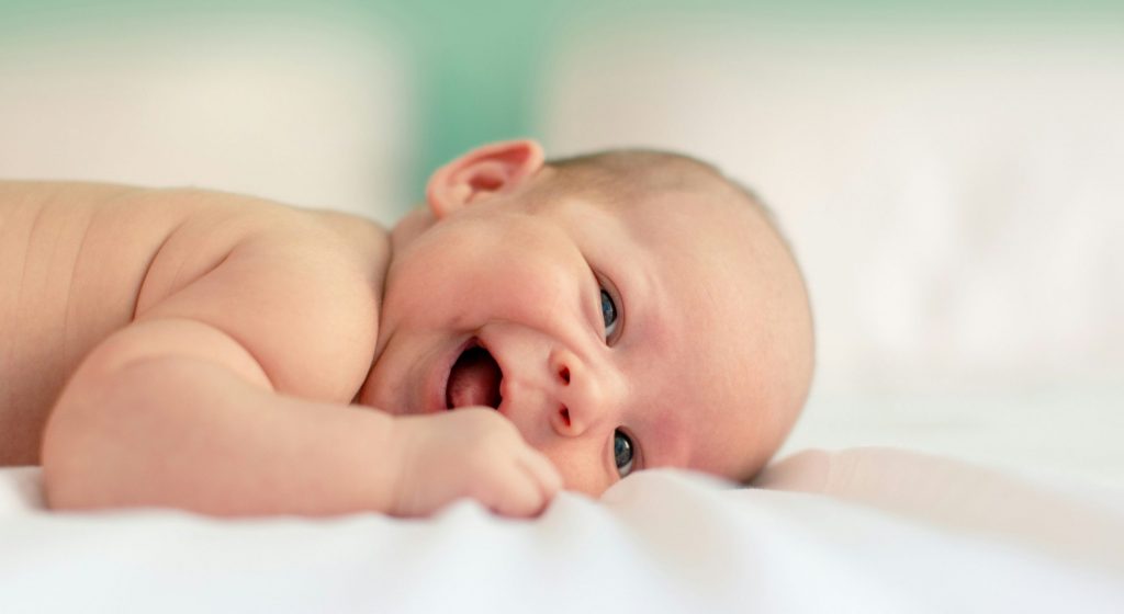 Baby lying on a fabic cloth. Photo by Filip Mroz on Unsplash